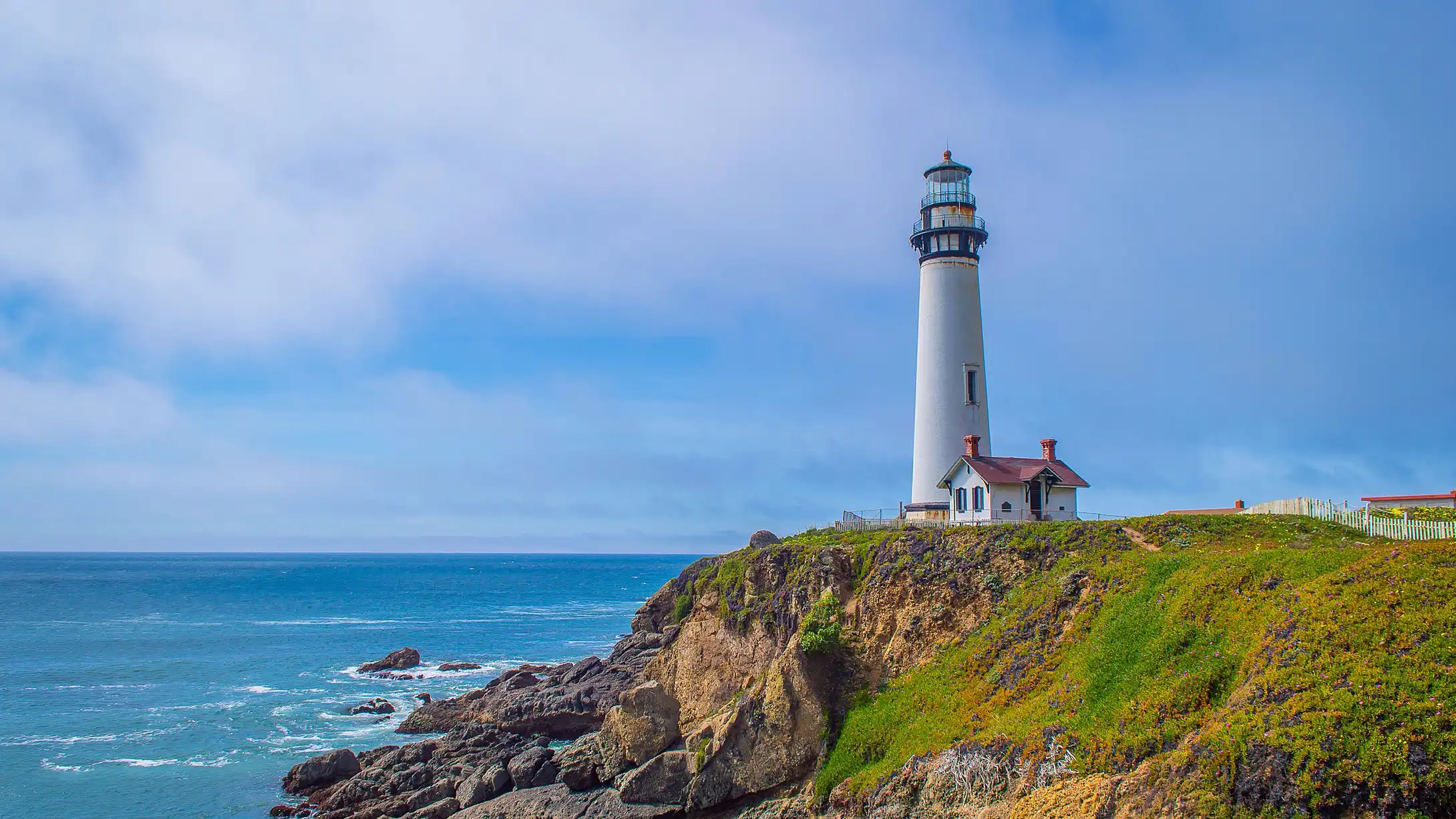 A lighthouse standing over calm ocean waters — a symbol of hope and guidance
